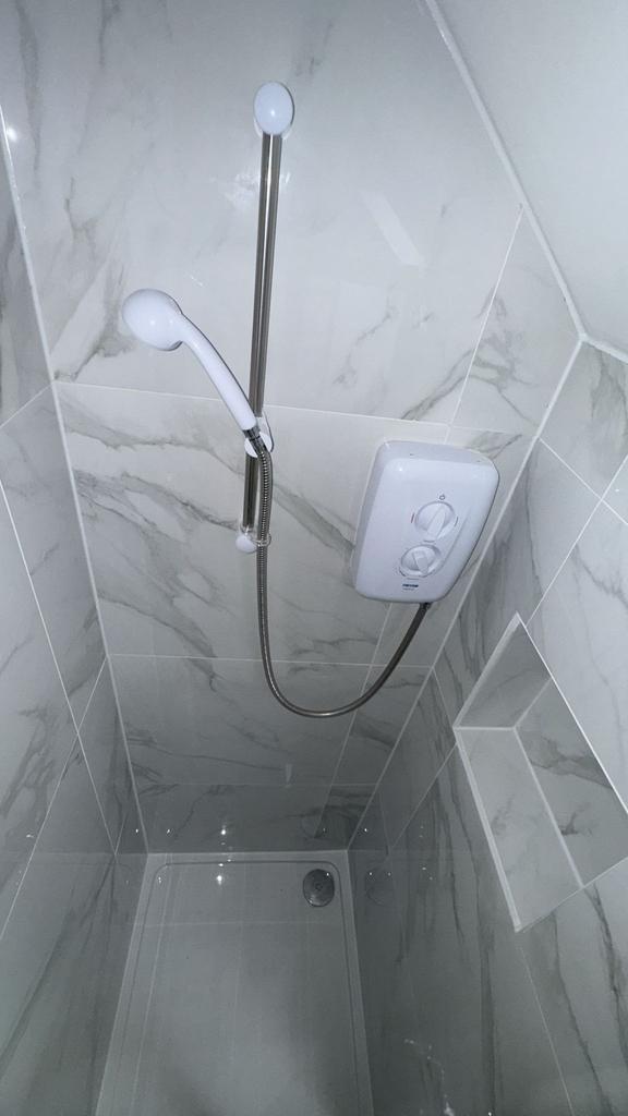 Modern tiled shower with adjustable handset...