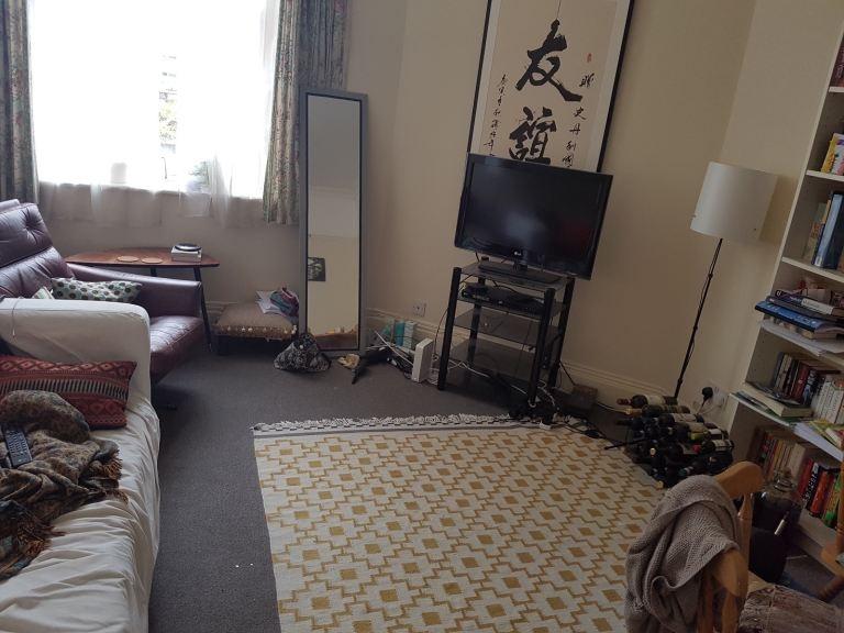 Cosy living room with patterned rug and seating...