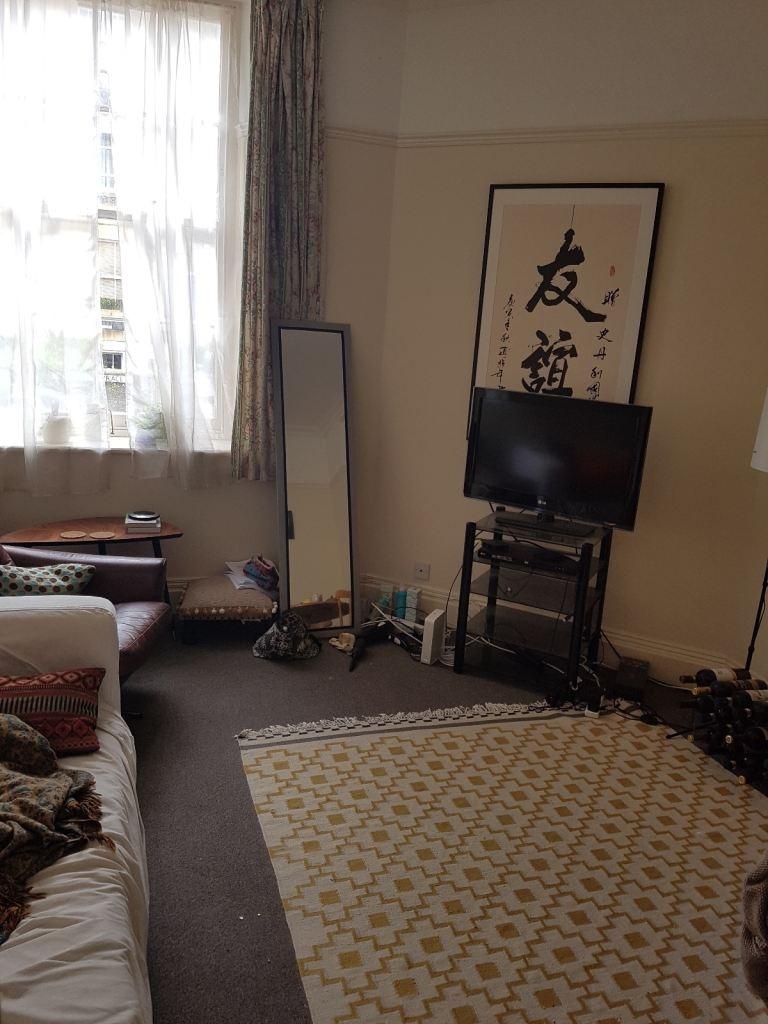 Bright, cosy living room with patterned rug...
