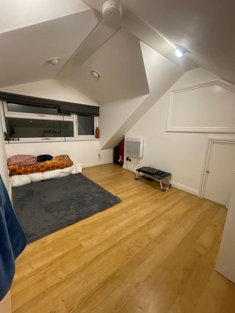 Cosy attic bedroom with sloped ceilings, large ...