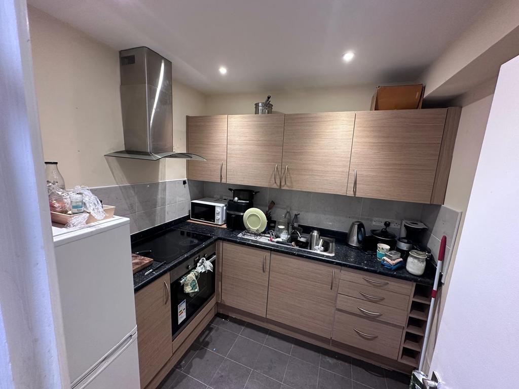 Modern galley kitchen with wood-effect cabinets...