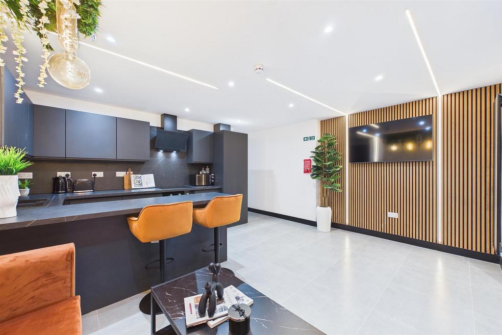 Modern communal lounge with kitchen island and ...