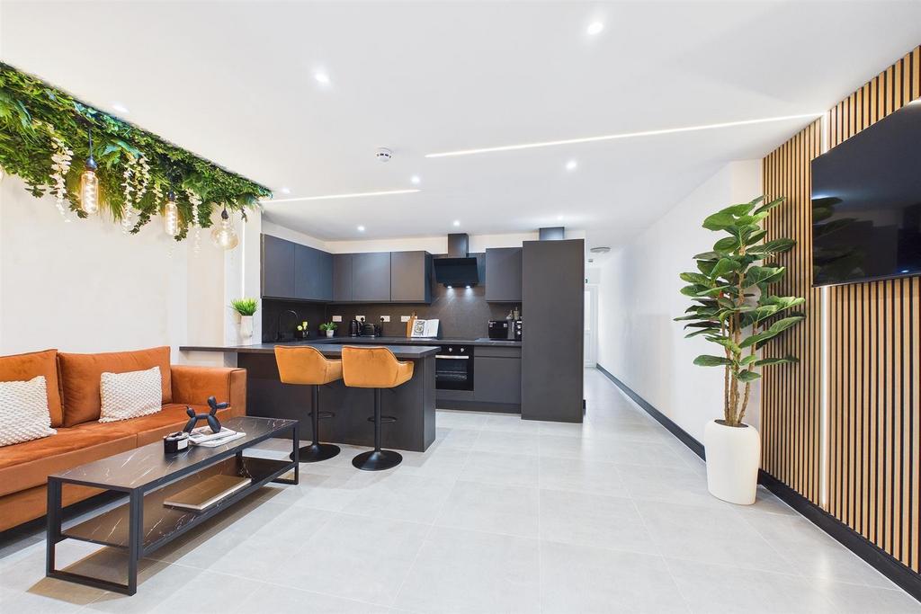 Modern open-plan living area with sleek kitchen...