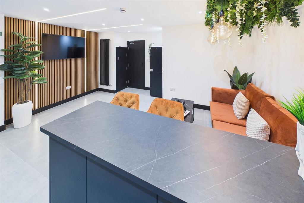 Bright modern communal lounge with seating and ...