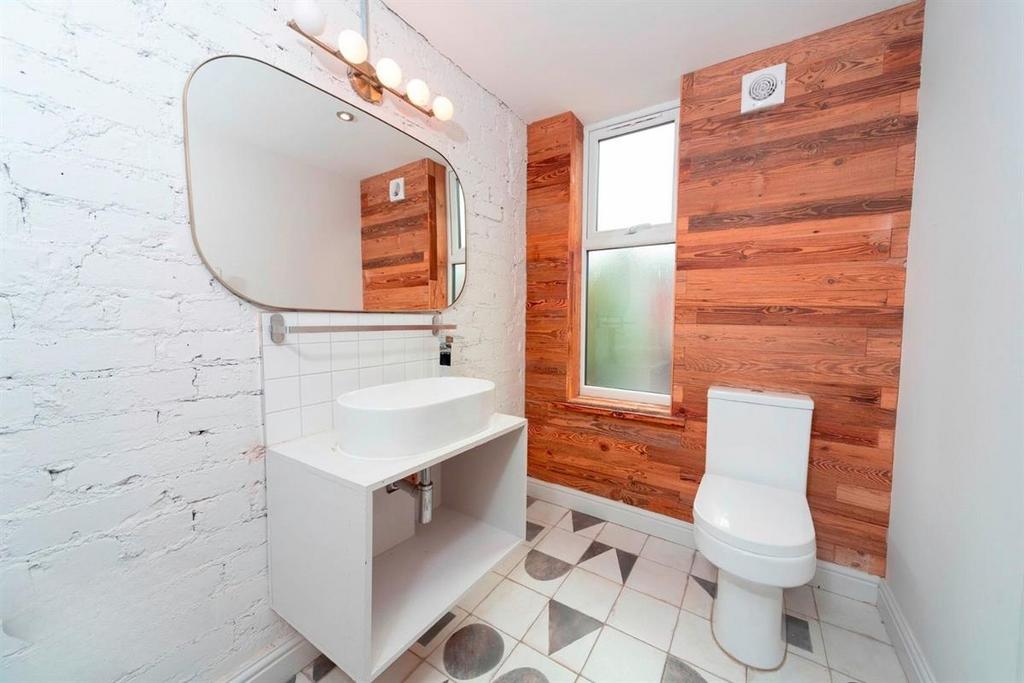 Modern bathroom with wood-paneled feature wall...