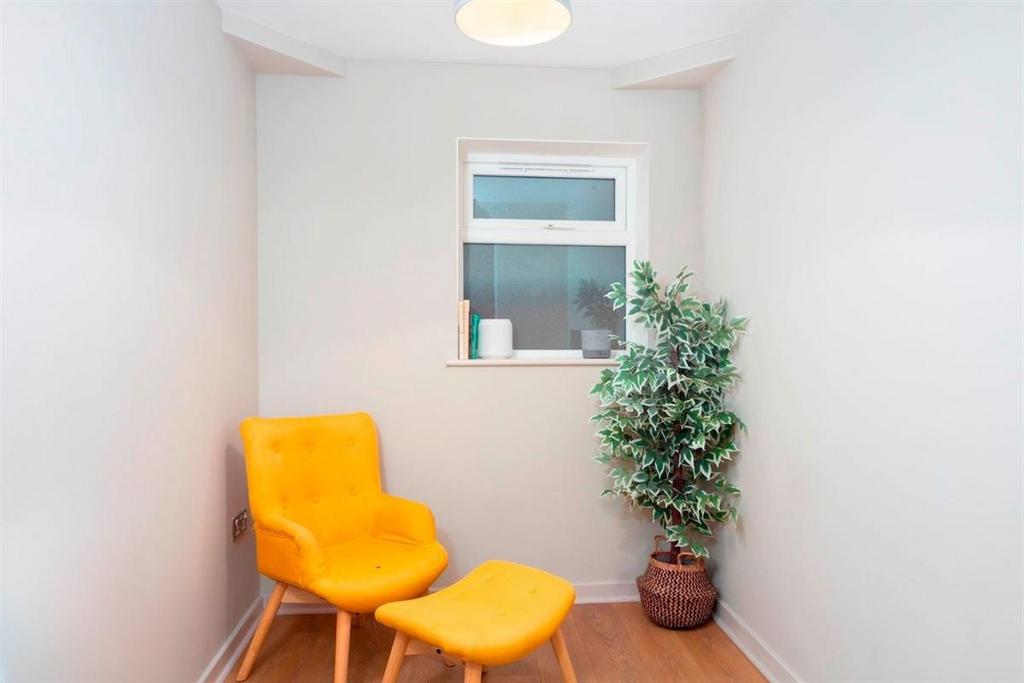 Cozy corner with bright accent chair and plant...