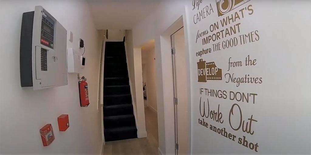 Bright, decorated entrance corridor with stairs...