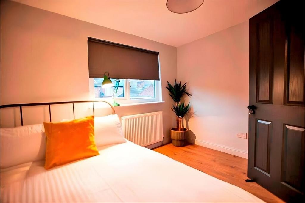 Cozy bedroom with bright accents and hardwoodfl...