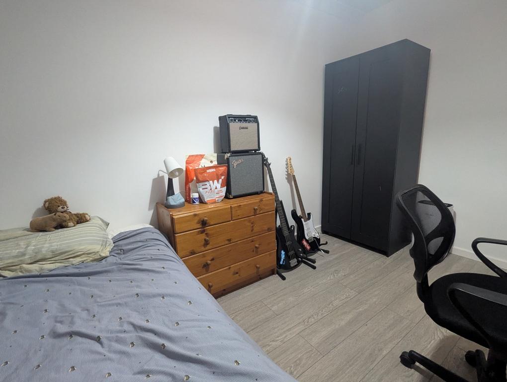 Neat, simply furnished bedroom with a single be...