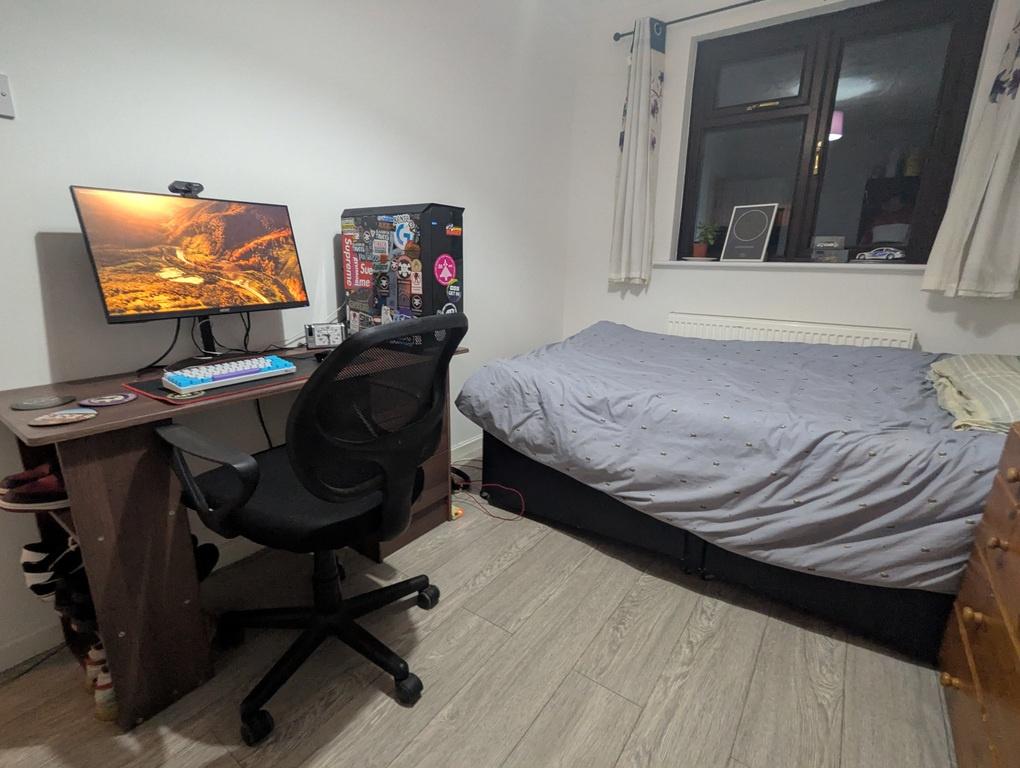 Cozy furnished bedroom with a single bed, desk ...