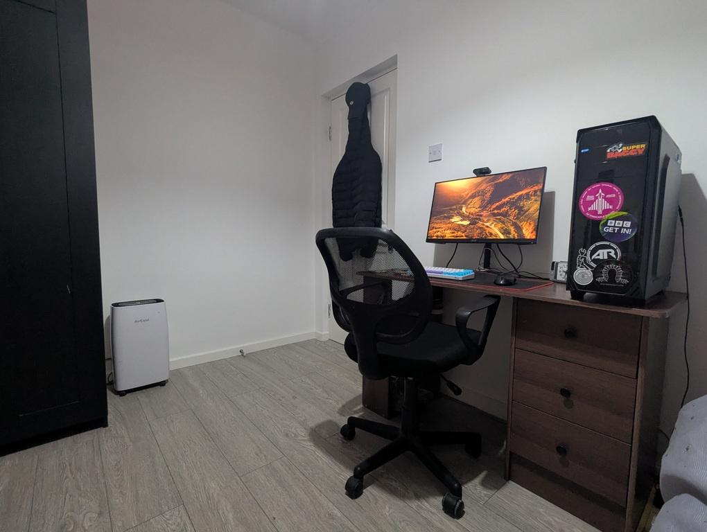 Compact, tidy bedroom setup with a dedicated st...