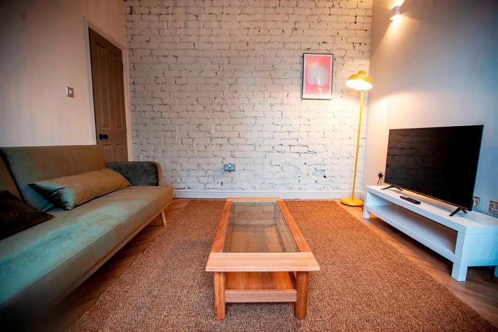 Cozy lounge with sofa, TV and coffee table...