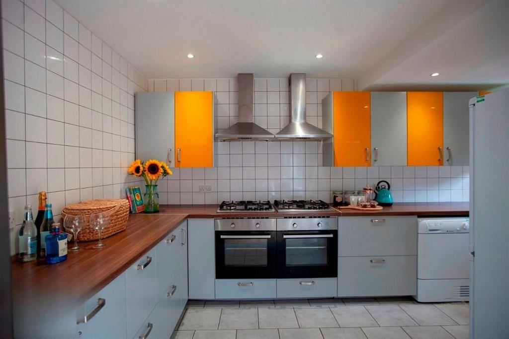 Modern kitchen with bright cabinetry and oven...