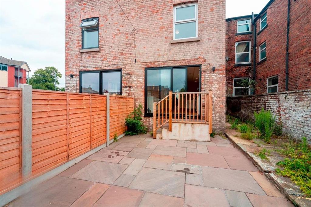 Private paved rear garden with patio area...