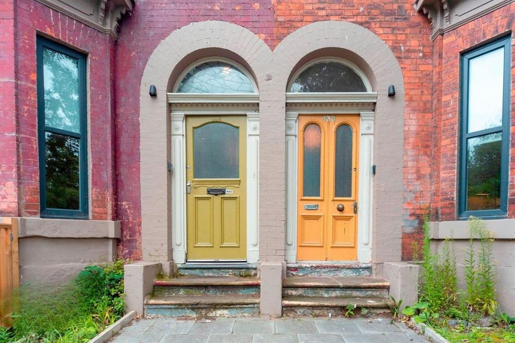 Attractive twin front doors with decorative bri...