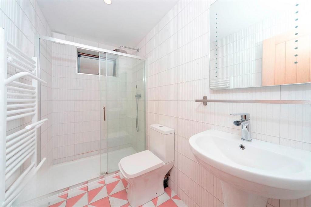 Bright modern bathroom with walk-in shower...