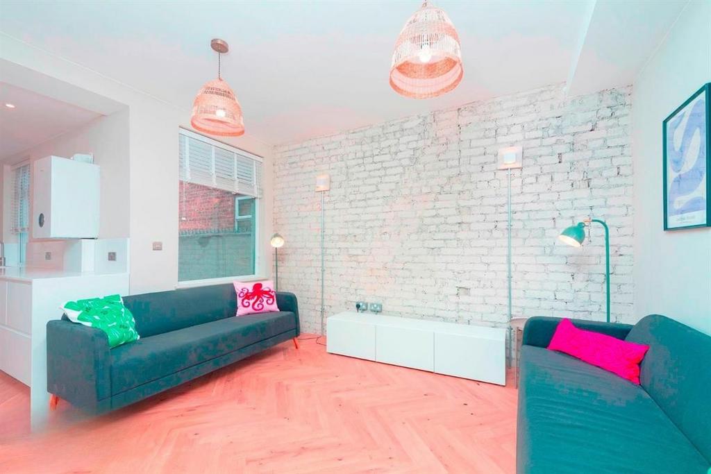 Bright modern living room with exposed brick...