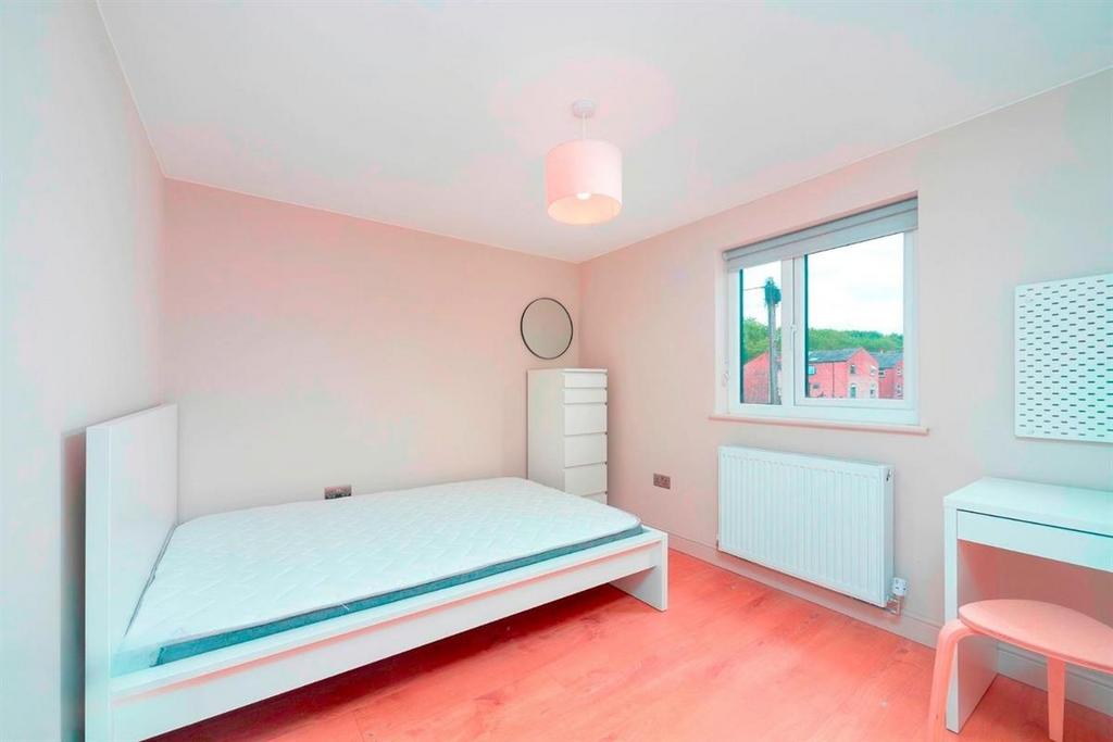 Bright, neat bedroom with bed and desk...