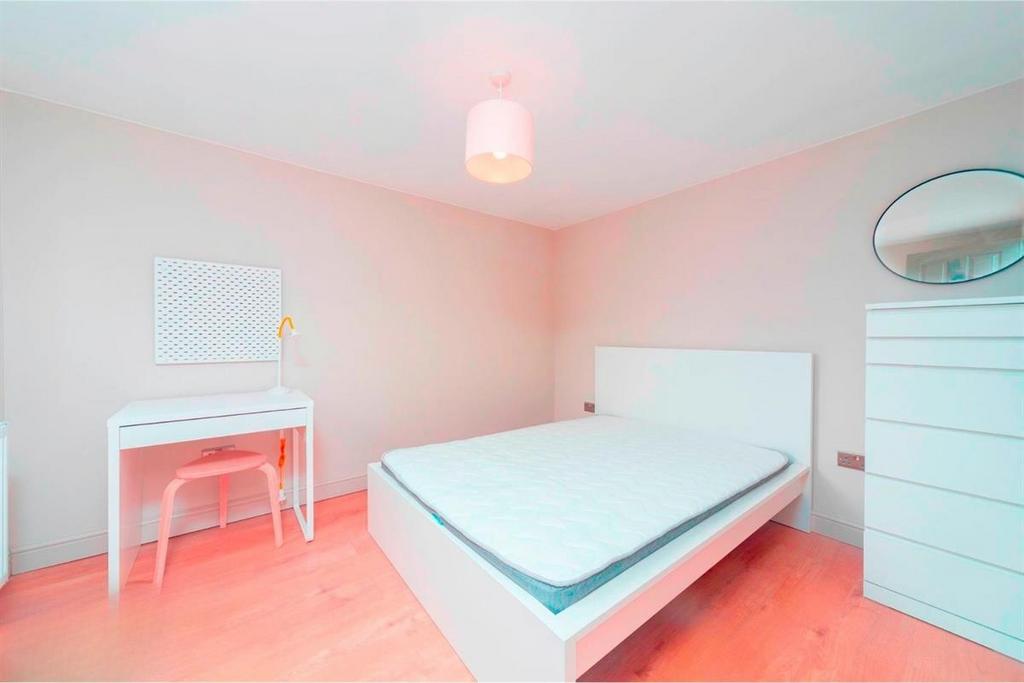 Bright, minimal double bedroom with white fitti...