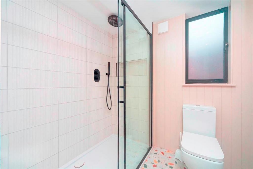 Bright modern bathroom with walk-in shower...