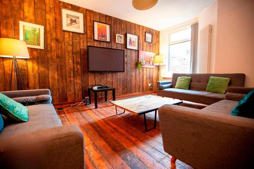 Bright lounge with wooden floors and comfy sofa...