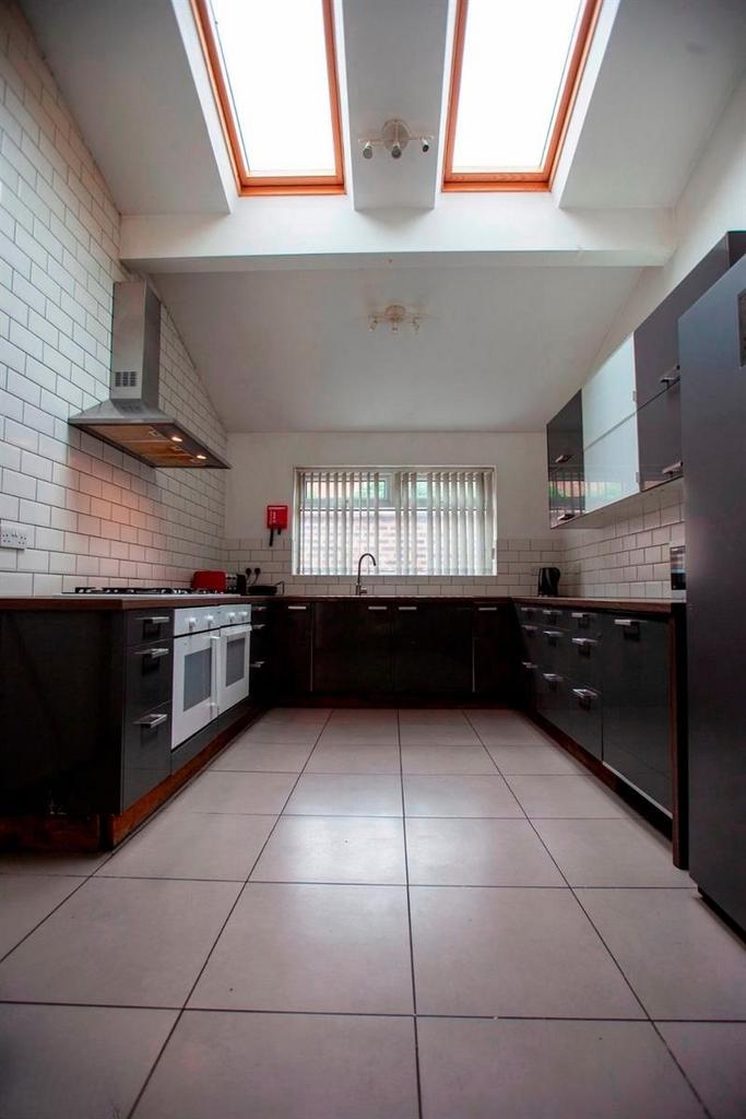Modern kitchen with skylights and sleek units...