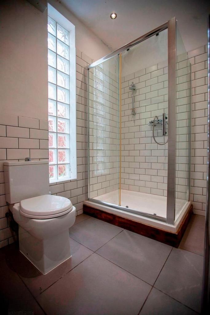 Bright modern bathroom with large walk-in showe...