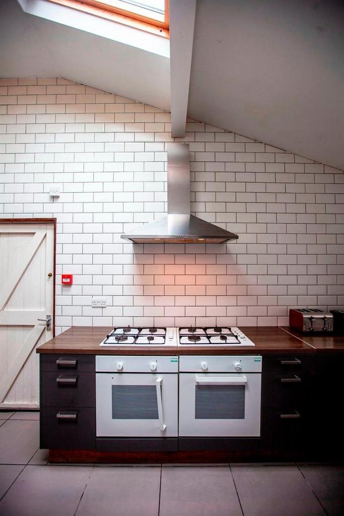 Stylish kitchen with twin ovens and extractor h...