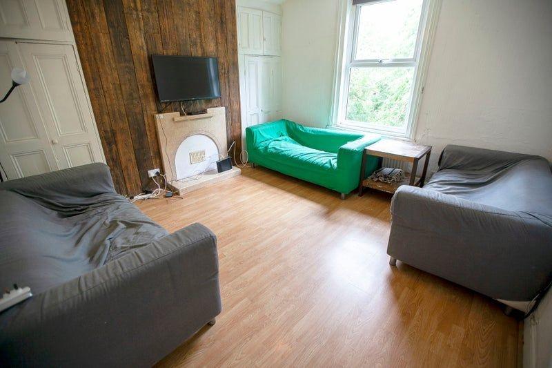 Bright communal lounge with wood flooring...