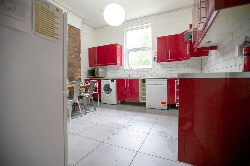Bright modern kitchen with red units...