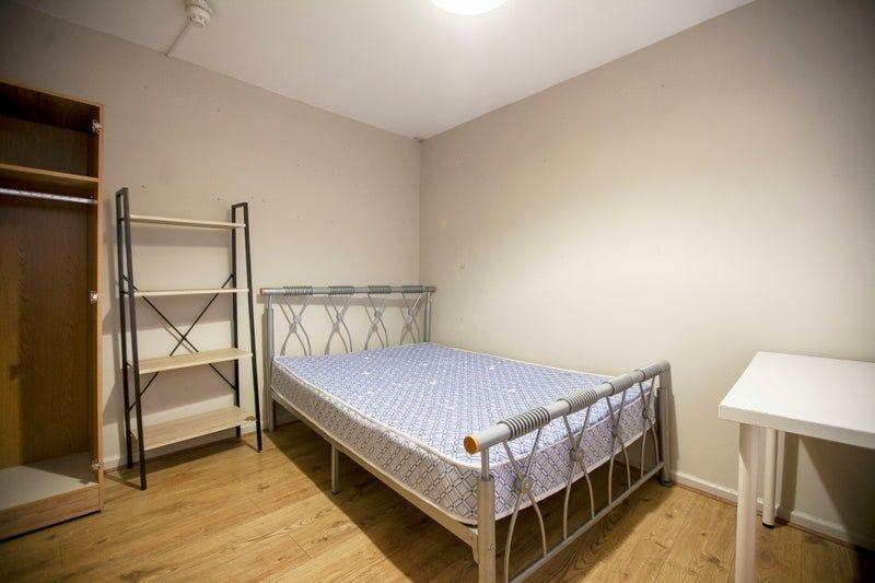 Neat double room with metal bed and desk...