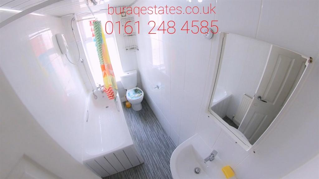 Bright white bathroom with bath and window...