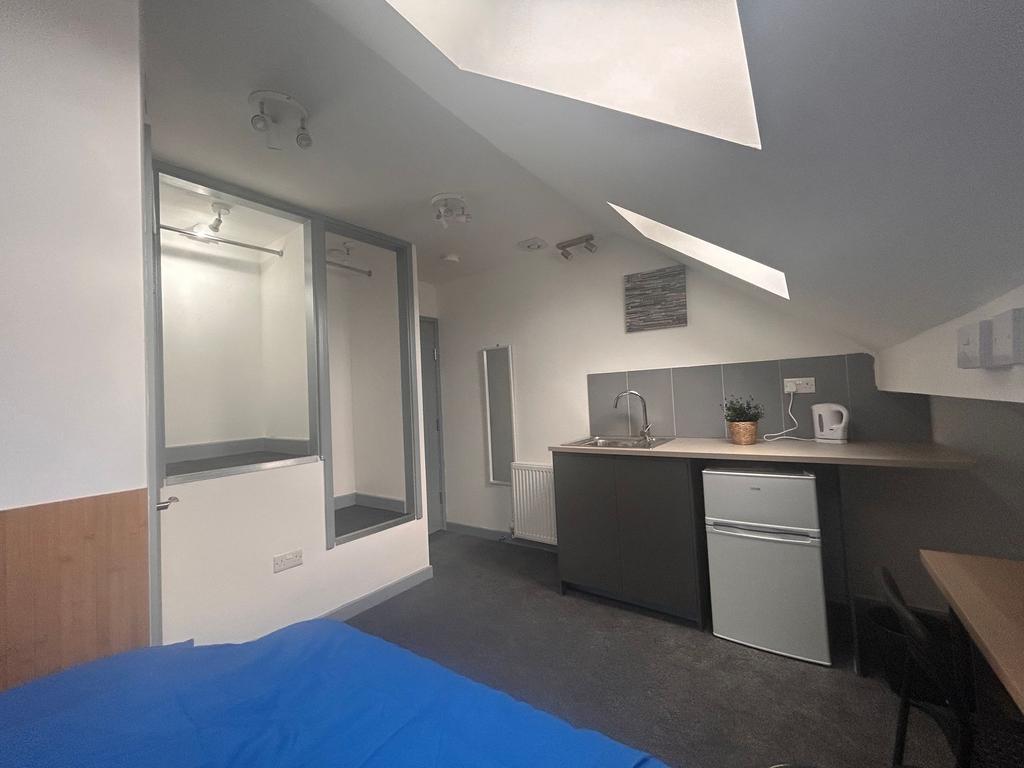 Bright loft room with kitchenette and storage...