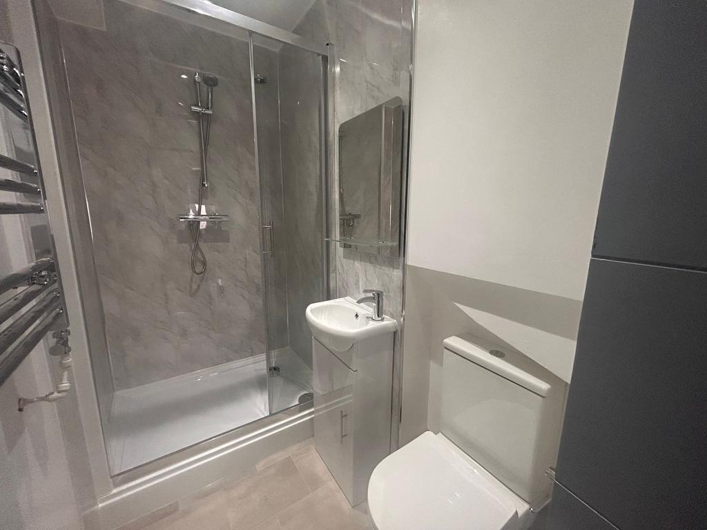 Modern bathroom with glass shower and sleek fit...