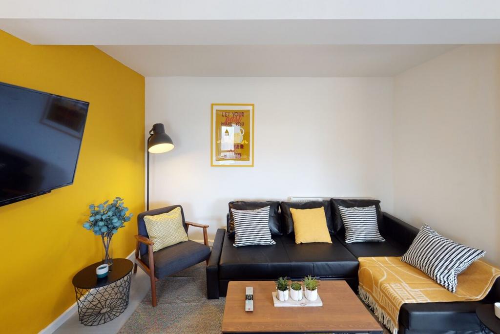 Bright, modern living room featuring a leather ...