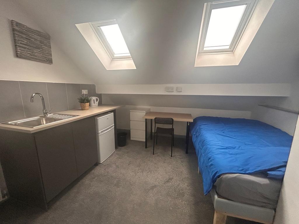 Bright loft room with kitchenette and desk...