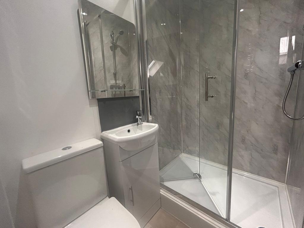 Modern bathroom with glass shower and vanity...
