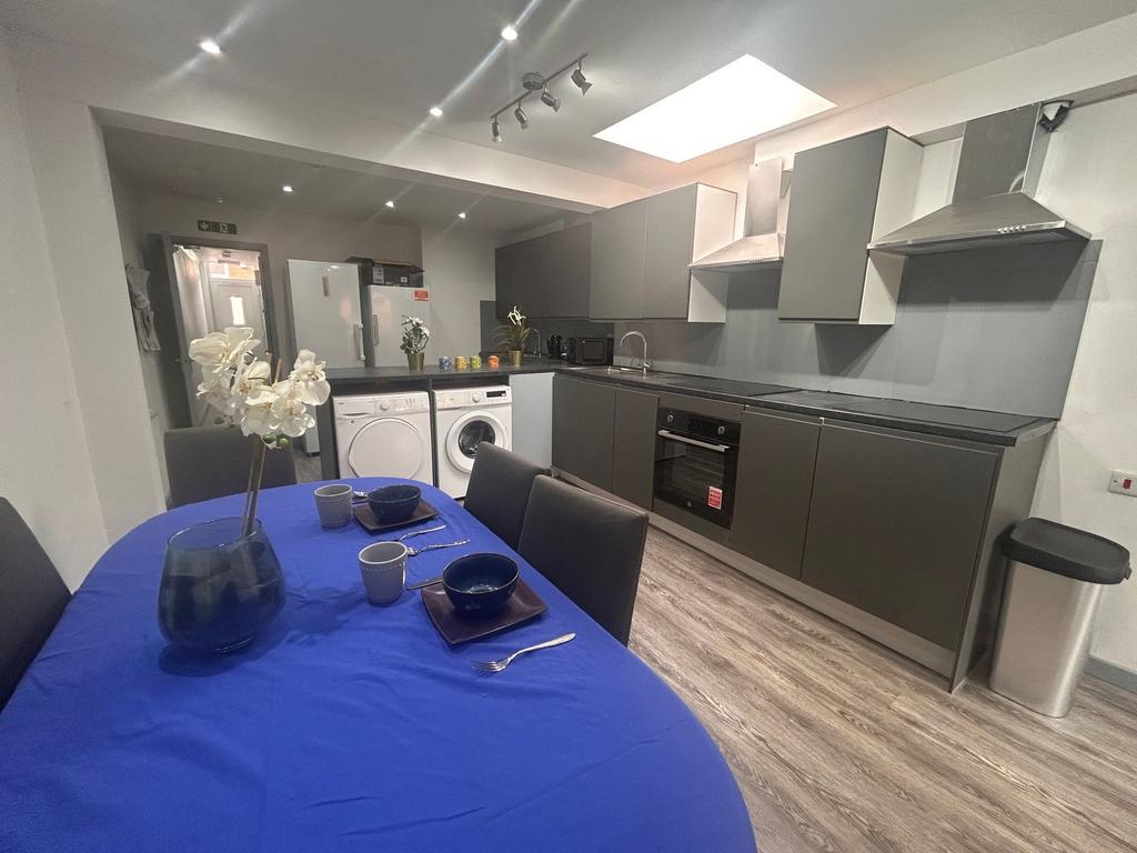 Modern fitted kitchen with dining table...
