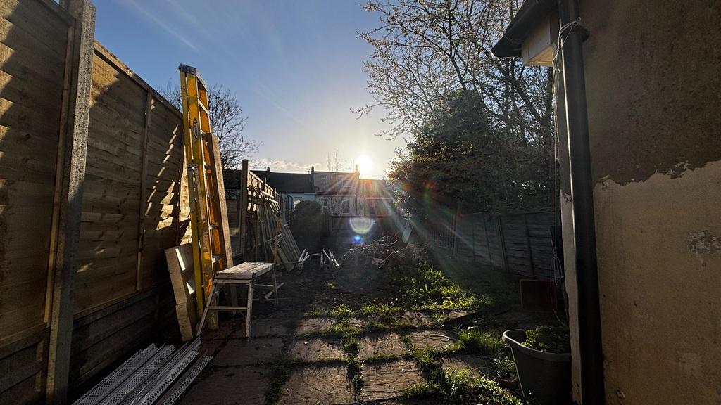 Sunlit private rear garden with paved patio...