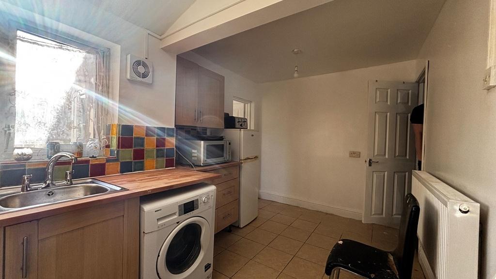 Compact kitchen with appliances and window ligh...