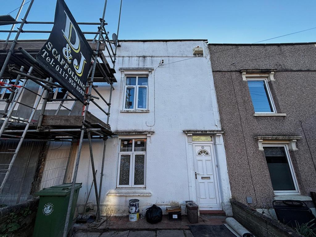 Two-storey terraced house with white facade...