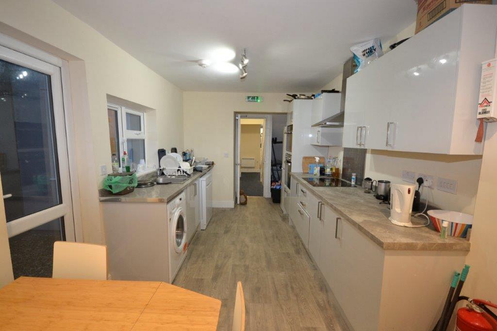 A spacious and well-lit kitchen with modern app...