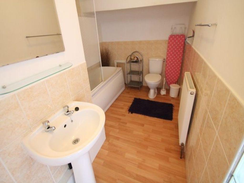 Bright bathroom with bath, sink and toilet...