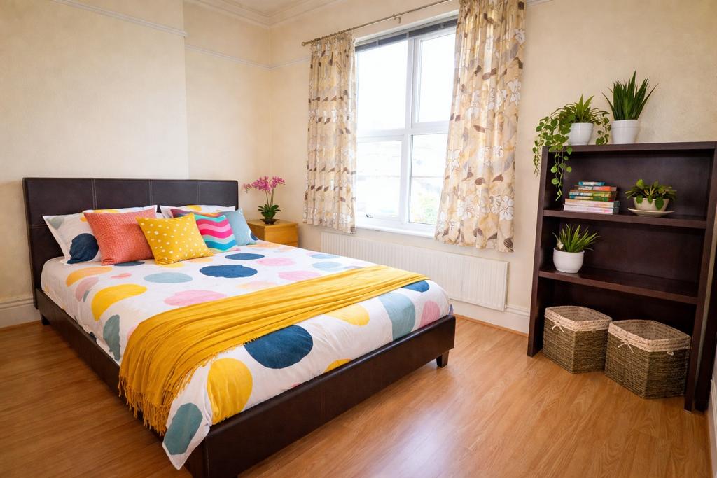 Bright, neatly styled double bedroom with a pat...