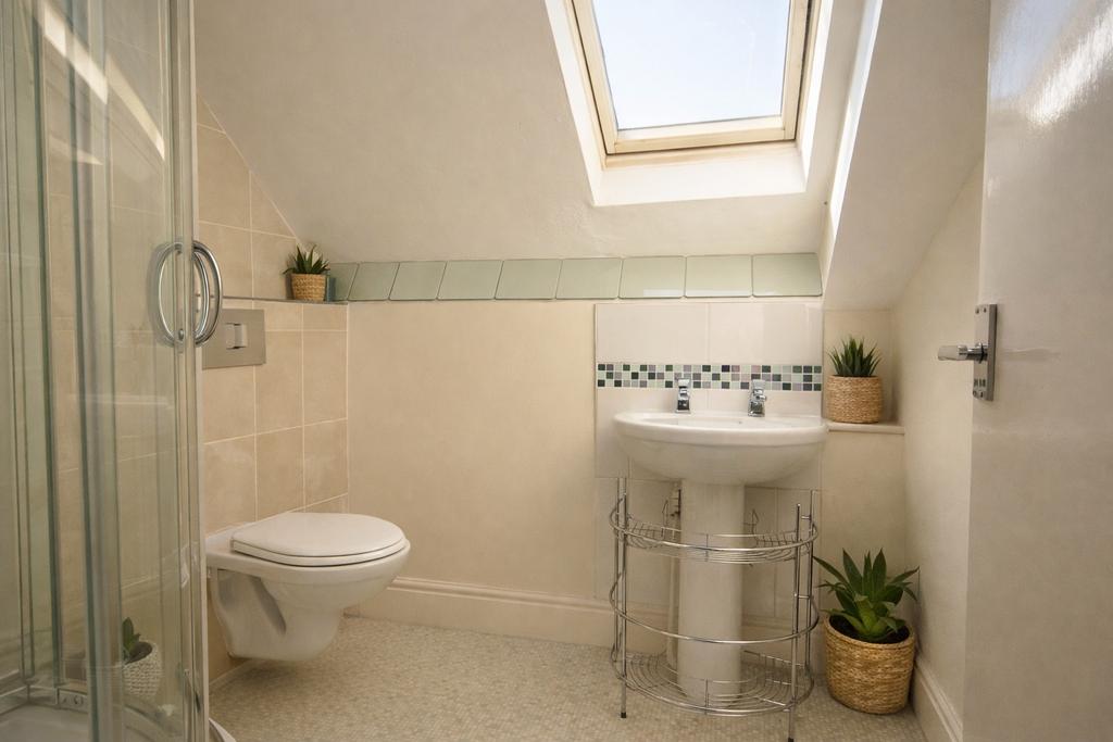 Bright, well-maintained bathroom with a skyligh...