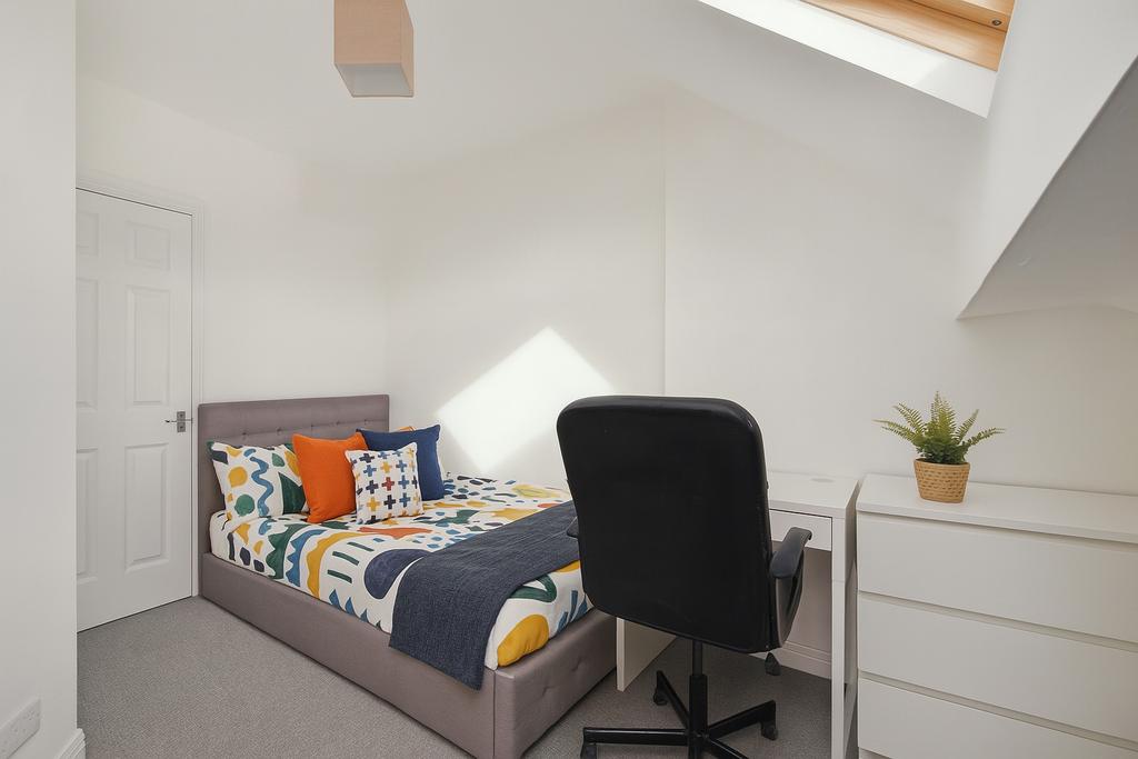 Bright, modern bedroom with a comfortable doubl...
