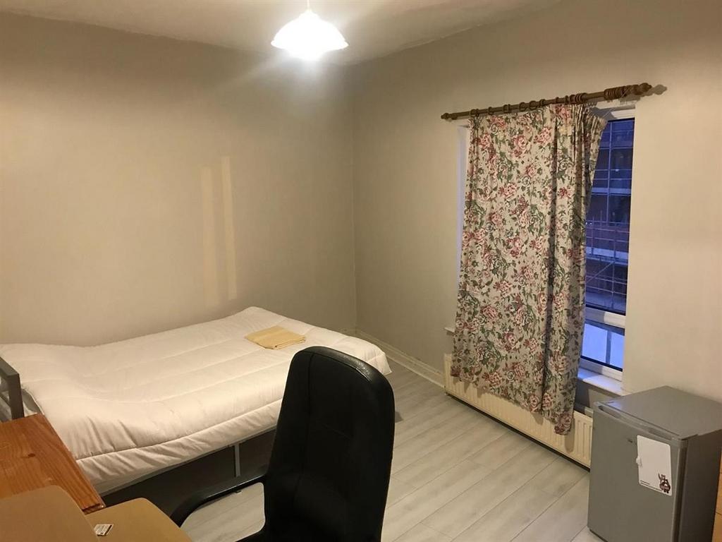 Bright simple bedroom with bed and desk...