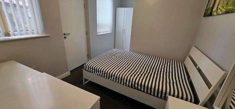 Bright double bedroom with wardrobe and desk...