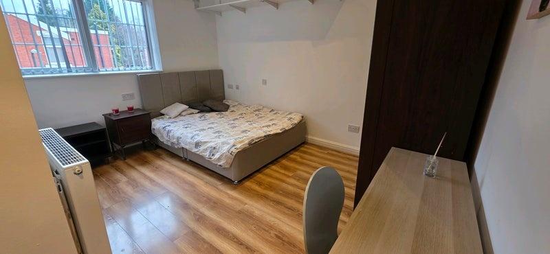 Bright room with large window and desk...