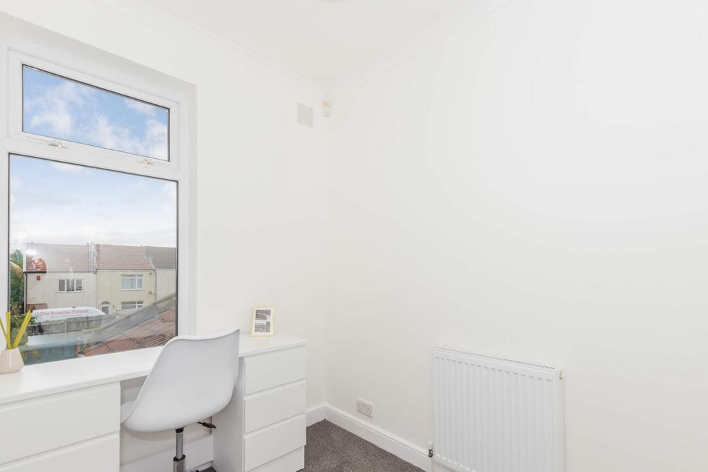 Bright, neat room with desk by the window...